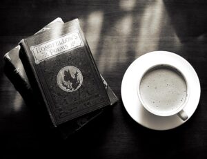 A captivating vintage still life of a coffee cup and Longfellow's poems book